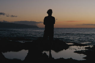 Arto Saari standing on reef looking out to sea.