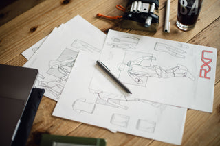 The Bolen titanium twist pen on a stack of sketches.