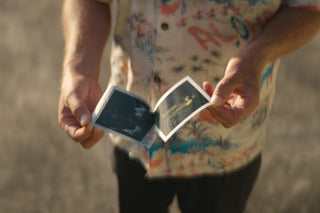 Arto Saari exposing a polaroid photo.