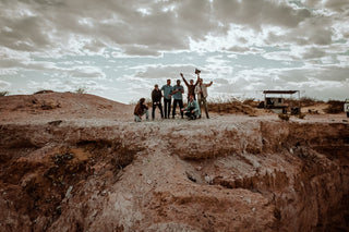 A group of people posing near a canyon.